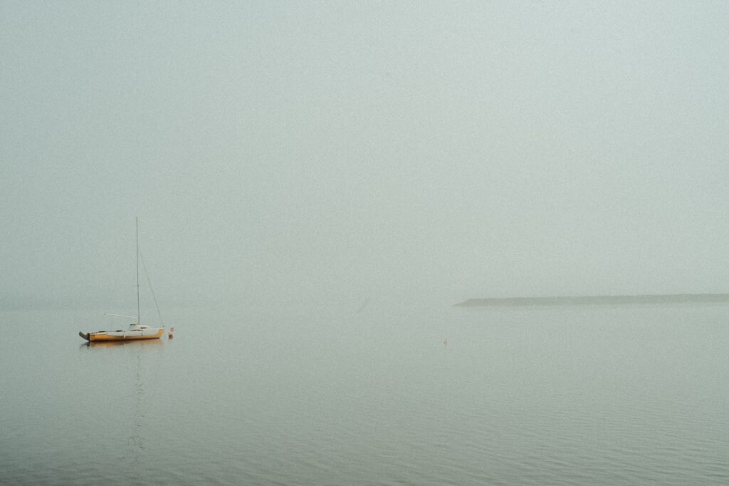 Sailboat floating on calm water at dawn — nervous system regulation and polyvagal theory